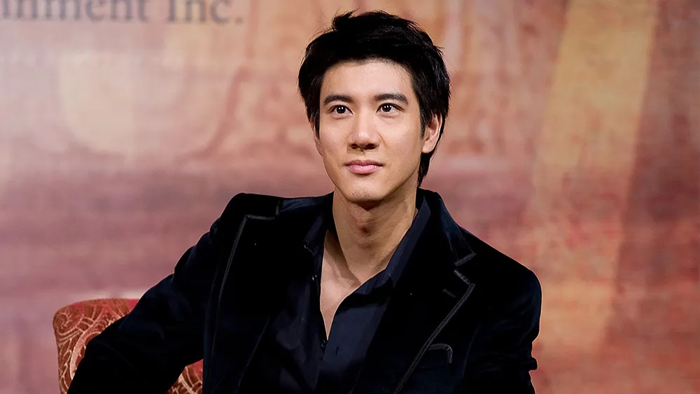 Wang Leehom in a professional portrait wearing a black velvet blazer, showcasing his sophisticated style as a renowned musician and actor